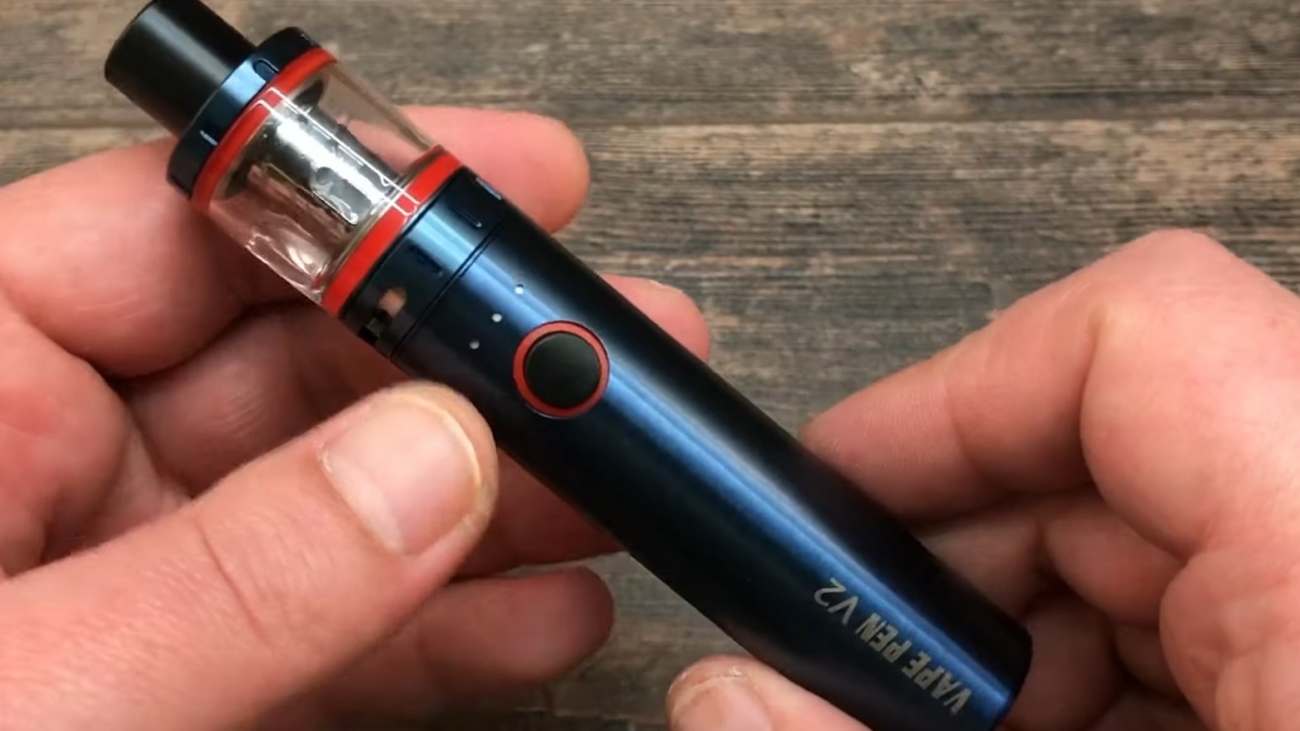 a person holding a vape pen